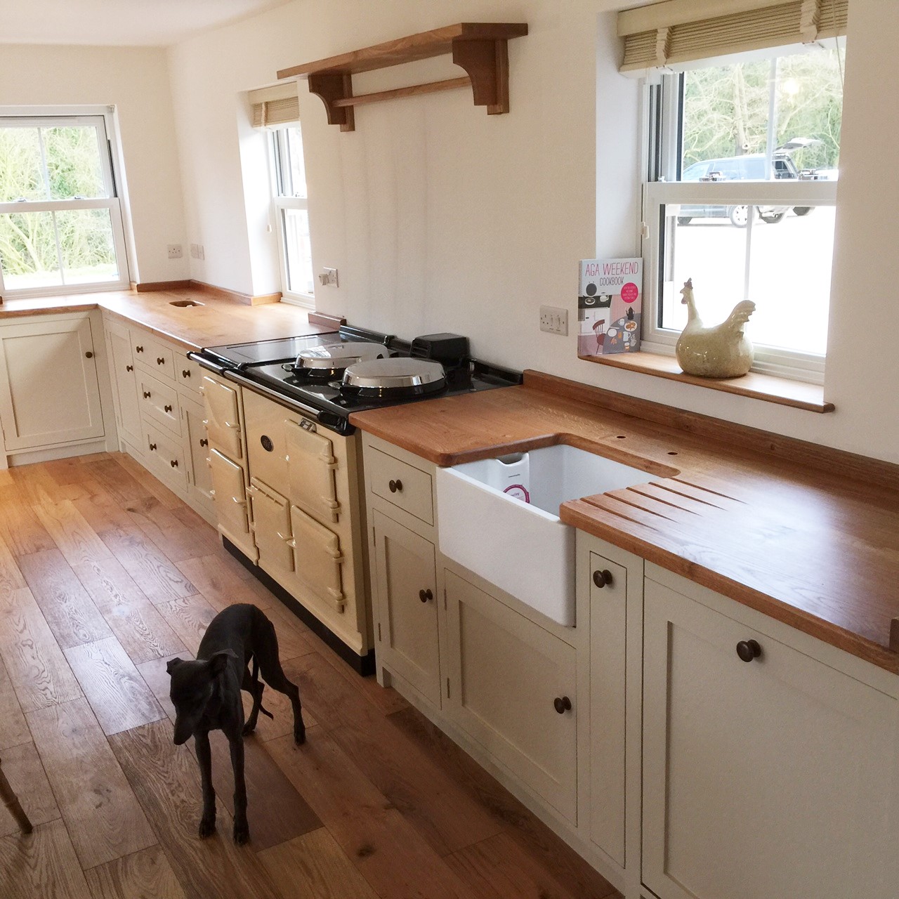 Bespoke hand built kitchen in solid wood shaker style with wide plank oak surface tops .Belfast sink.