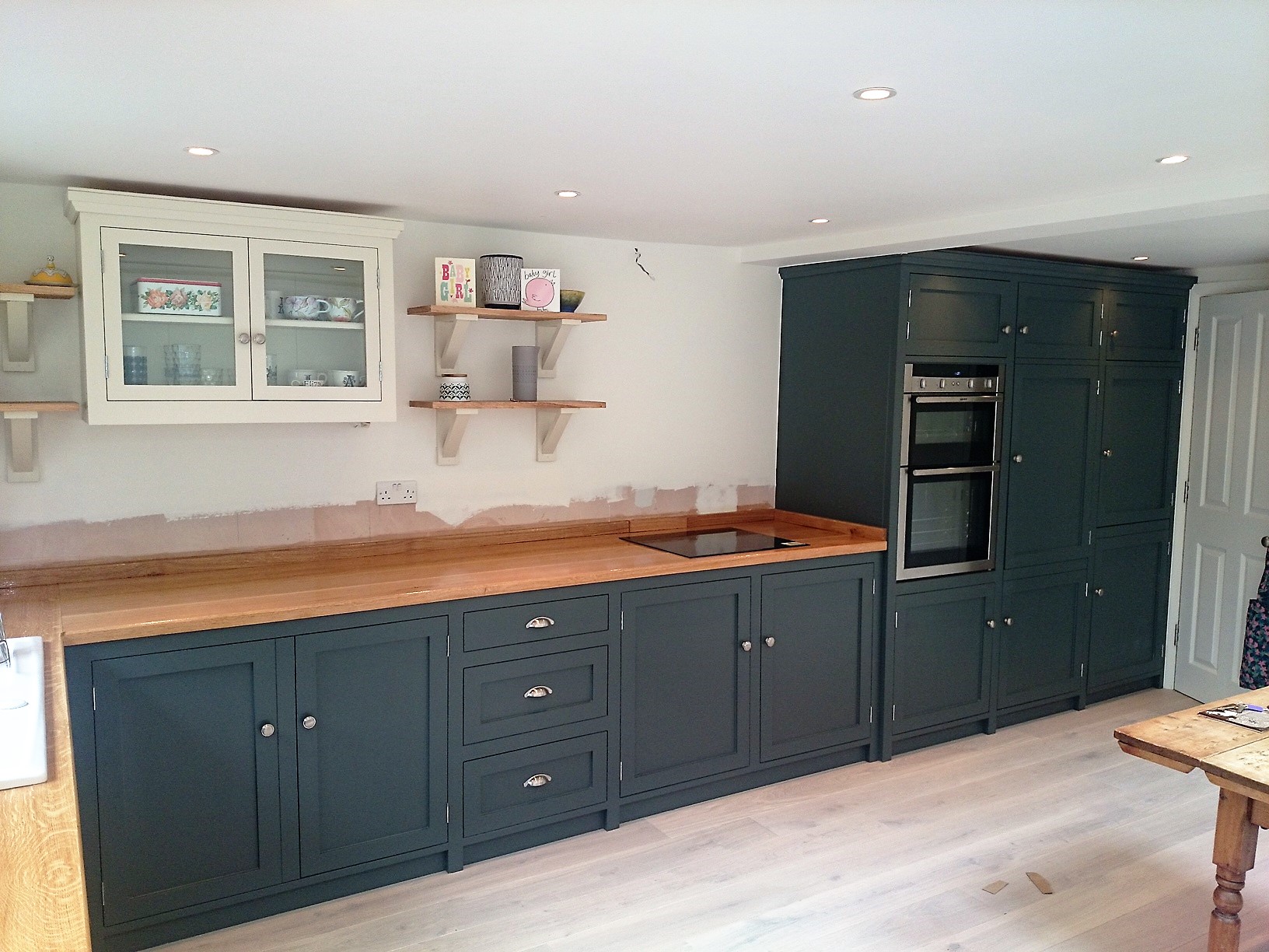 Fulle bespoke,shaker style fitted kitchen hand built from solid wood with wide plank solid oak surface tops.